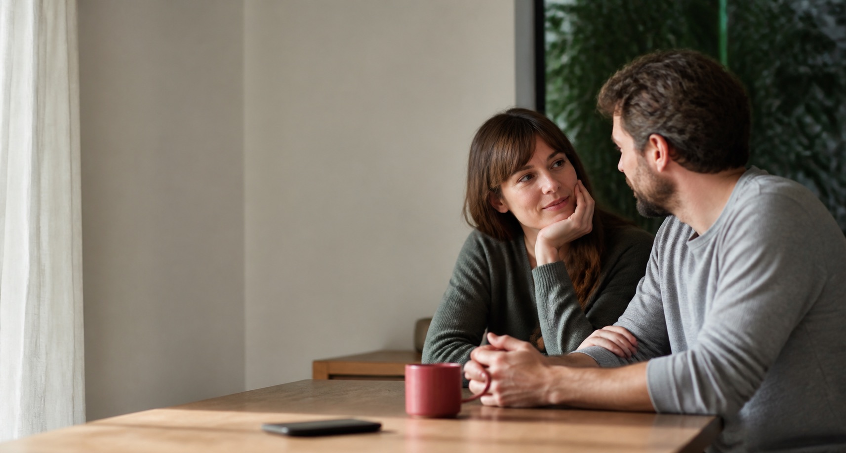 A couple having a quiet conversation at home